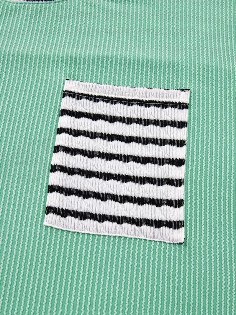 Black and white striped pocket on a green shirt