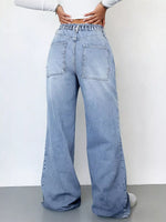 Light blue jeans worn by a person on a plain background