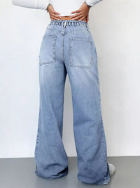 Light blue jeans worn by a person on a plain background