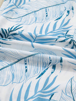 Close-up of blue leaf pattern fabric on a white background