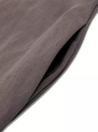 Close-up of a brown fabric with folds on a white background