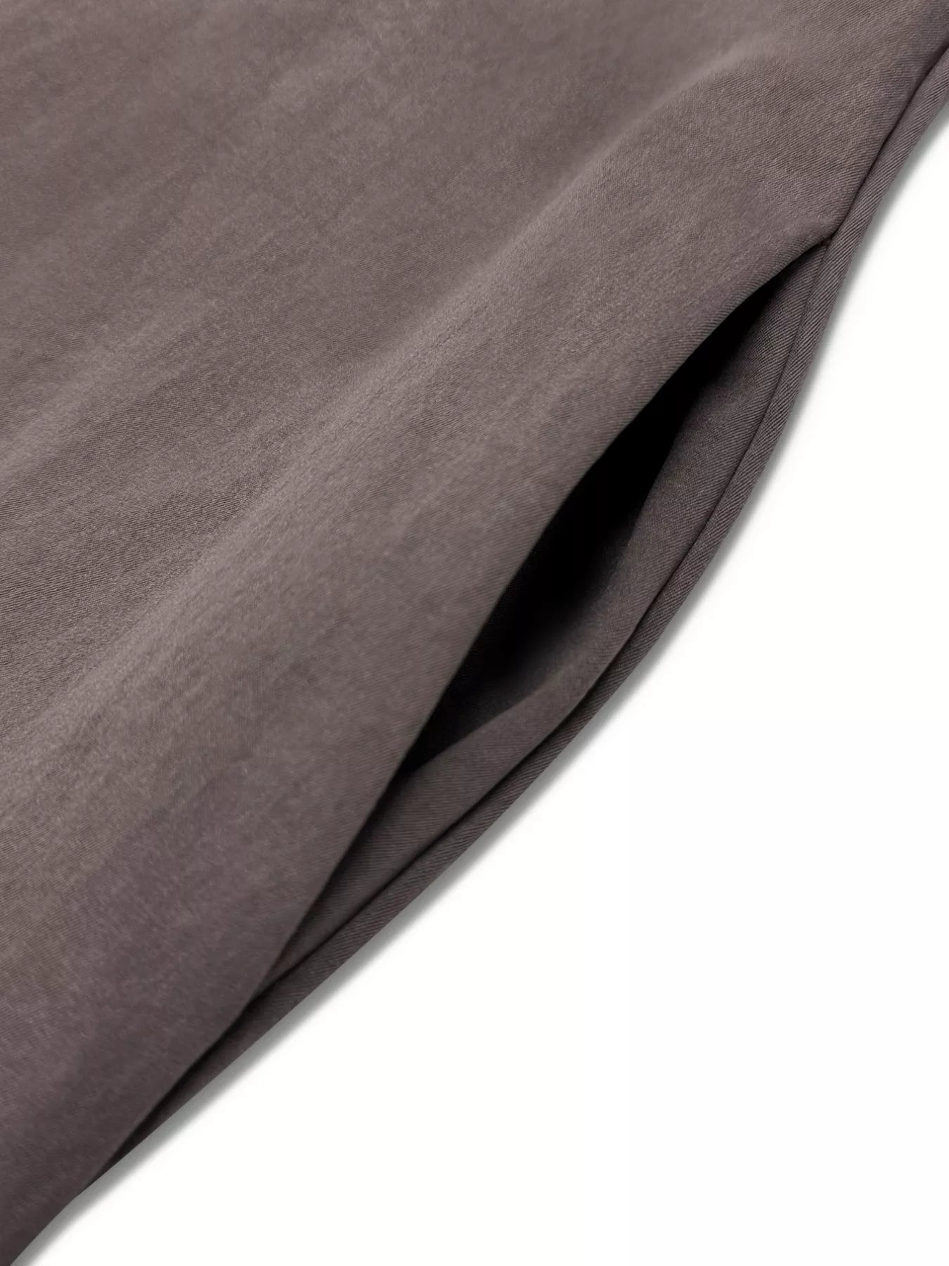 Close-up of a brown fabric with folds on a white background
