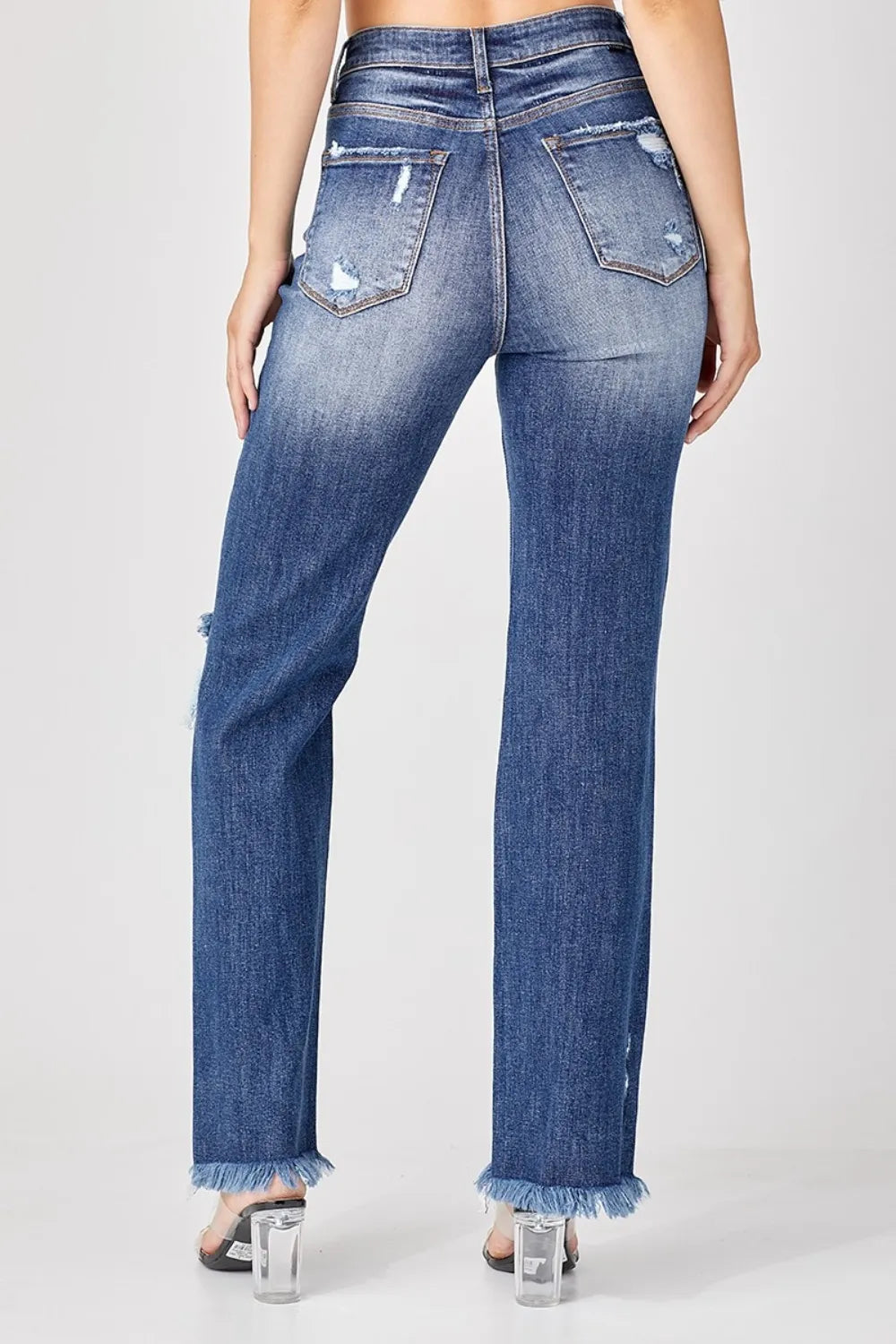 Blue jeans with frayed hems on a white background