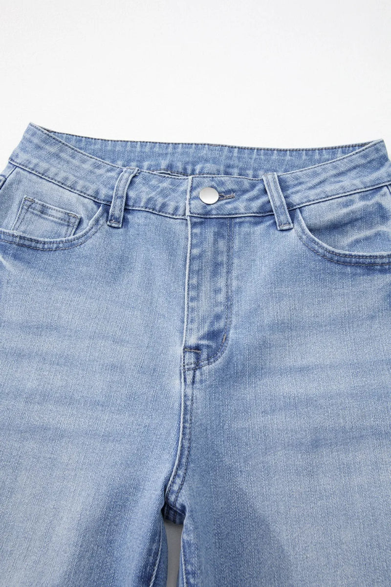 Close-up of a pair of light blue jeans on a white background