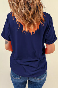 Person wearing a navy blue t-shirt with a beige background