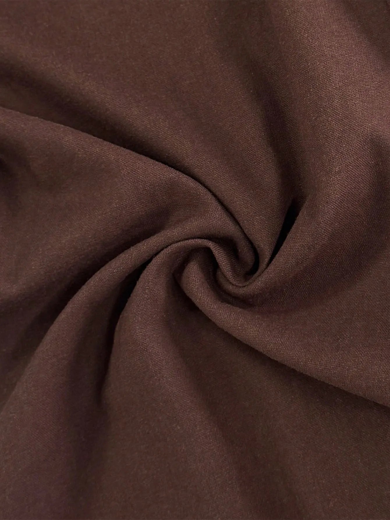 Close-up of brown fabric with folds