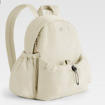 Beige backpack with a visible brand logo on a light gray background