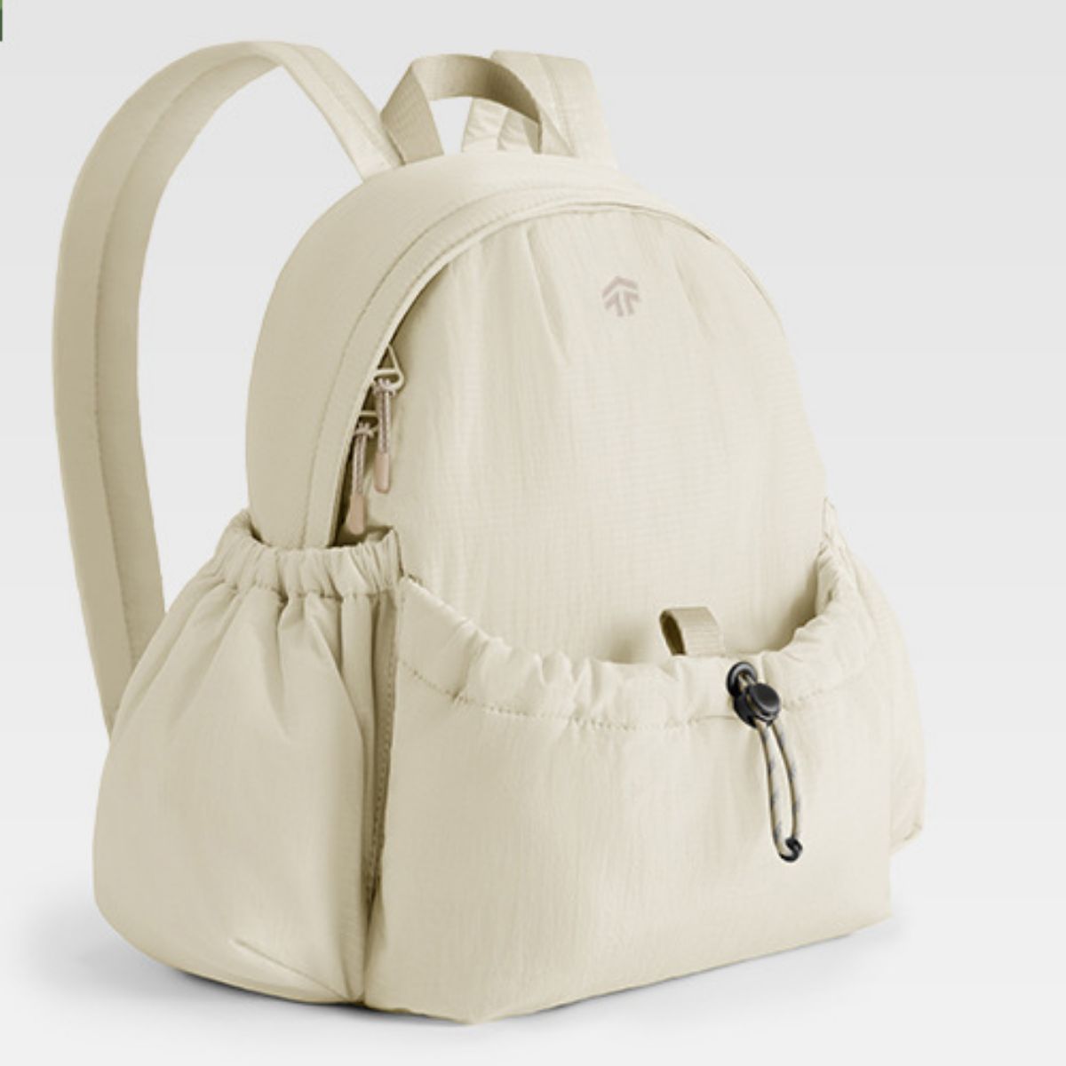 Beige backpack with a visible brand logo on a light gray background