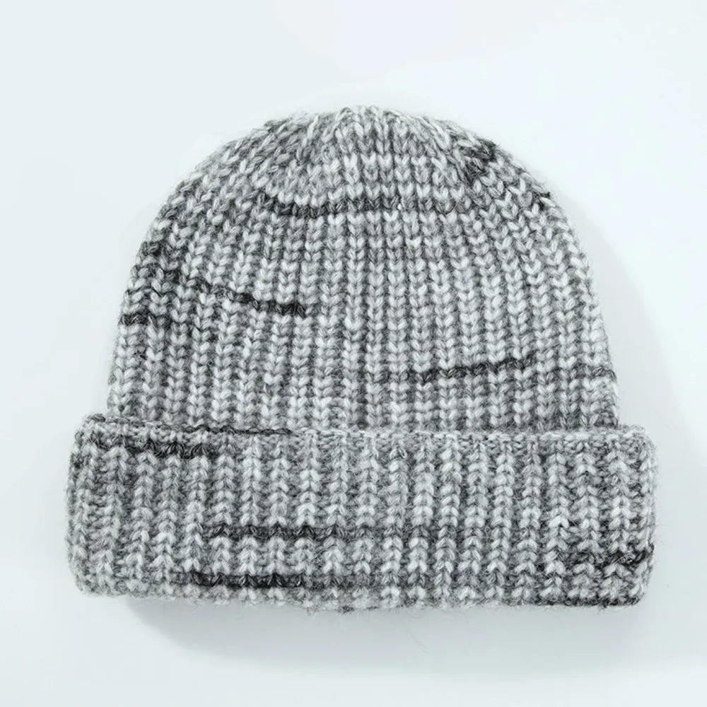 Knitted beanie with gray and black pattern on a white background