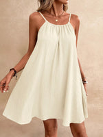 Woman wearing a white dress against a beige background