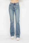Light blue jeans worn by a person on a white background