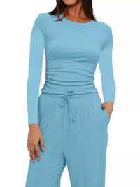 Light blue long-sleeve top and pants set on a white background