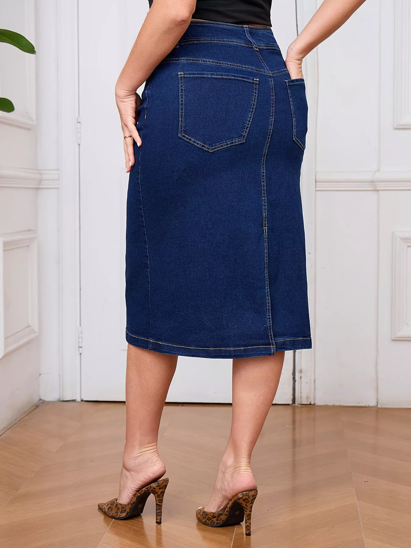 Person wearing a blue denim skirt in a room with white walls and wooden floor.