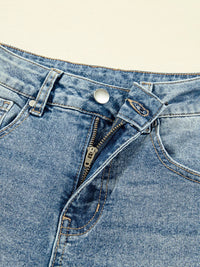 Close-up of a blue denim pocket with zipper and button on a beige background
