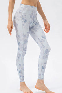 Light blue floral patterned leggings worn by a person on a white background