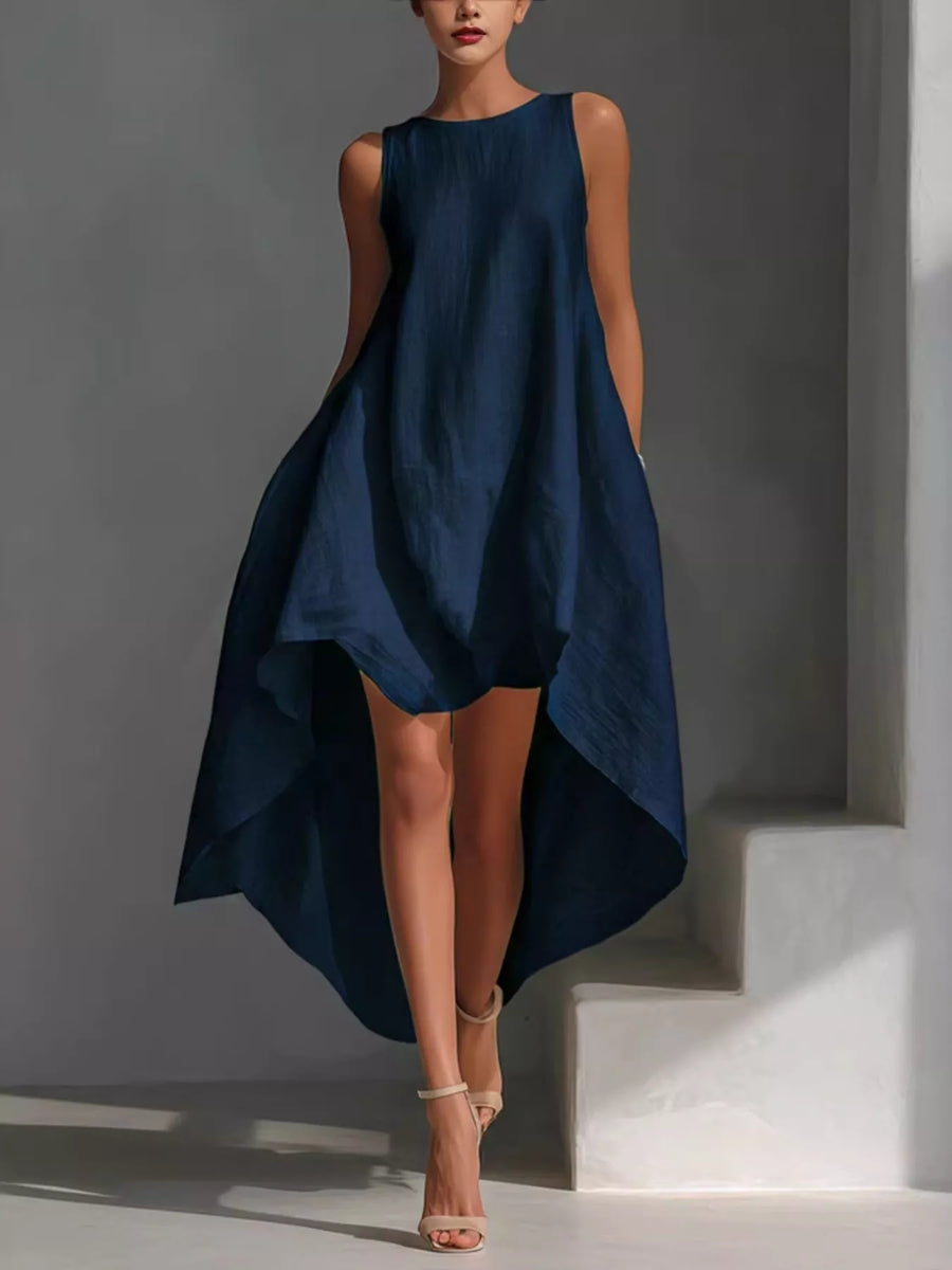 Woman wearing a navy blue dress against a gray background