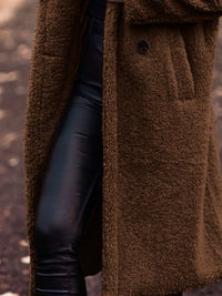 Brown textured coat with a blurred background