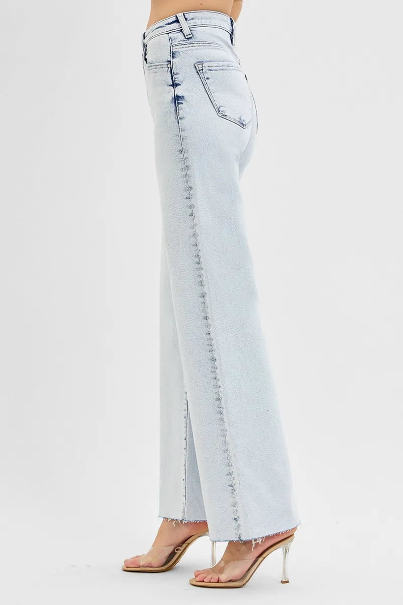 Light blue jeans worn by a person on a white background