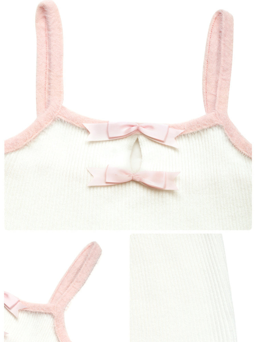 White baby romper with pink straps and bow on a white background