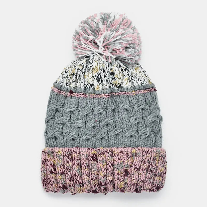 Knitted beanie with a pom-pom on a white background