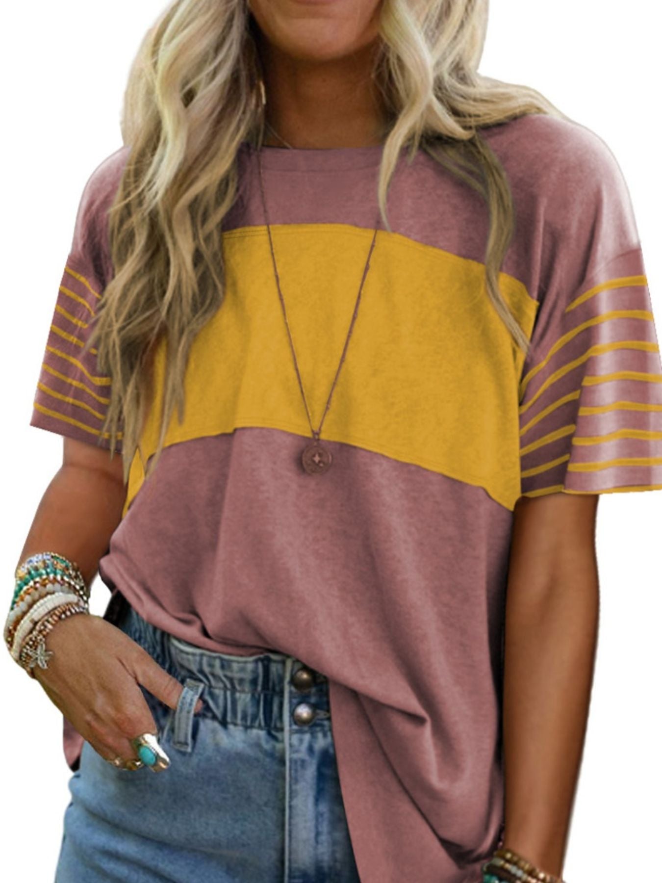 Woman wearing a purple and yellow striped shirt with denim shorts on a white background