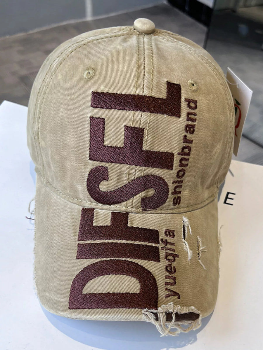 Beige cap with brown text on a white surface
