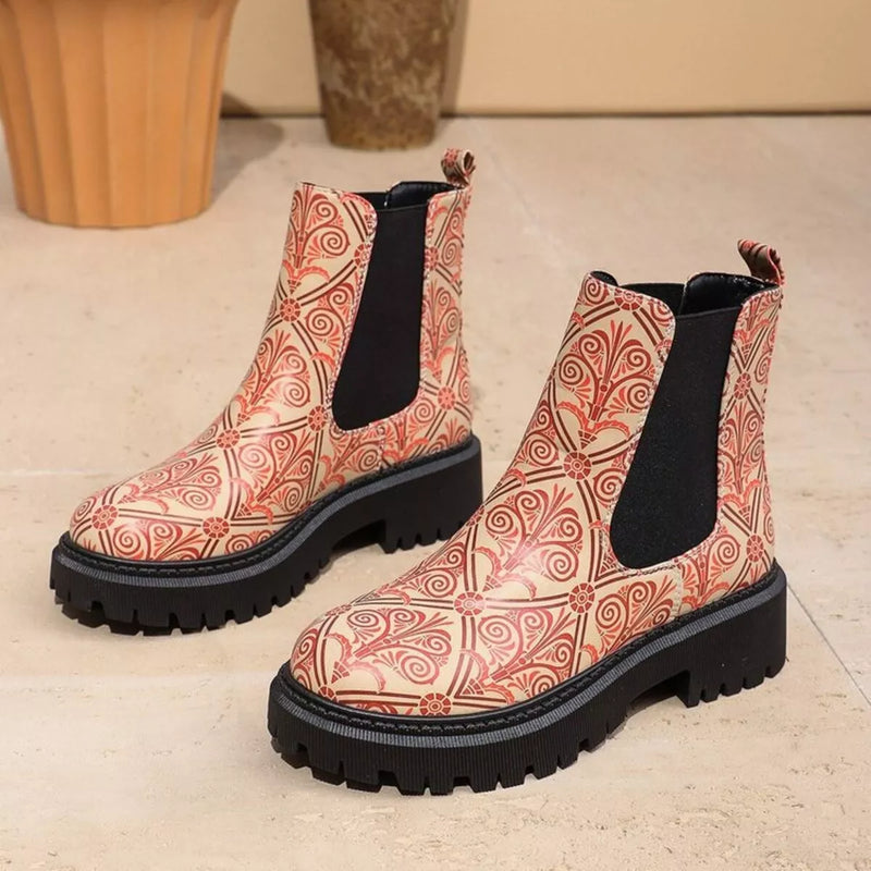 Patterned boots with black soles on a light background