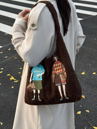 Brown textured bag with embroidered characters held by a person on a black and white striped background.