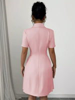 Person wearing a pink dress against a plain background