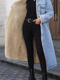 Person wearing a long coat with a teddy interior, black pants, and a denim jacket.