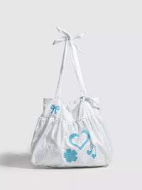 White bag with blue designs on a light gray background
