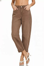 Brown pants worn by a person on a white background