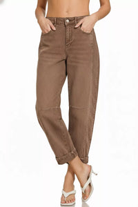 Brown pants worn by a person on a white background
