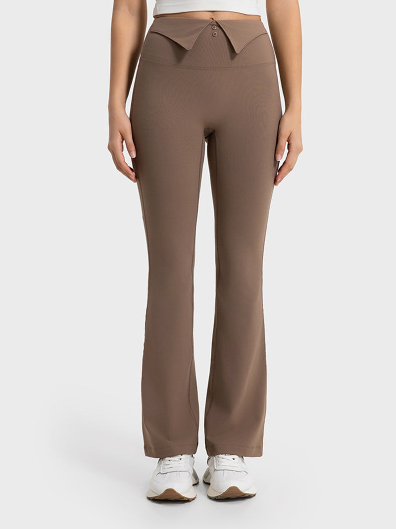 Brown high-waisted pants worn by a person on a white background