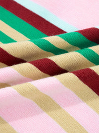 Close-up of fabric with multicolored stripes in red, green, beige, and pink.