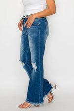Person wearing blue jeans with a white background