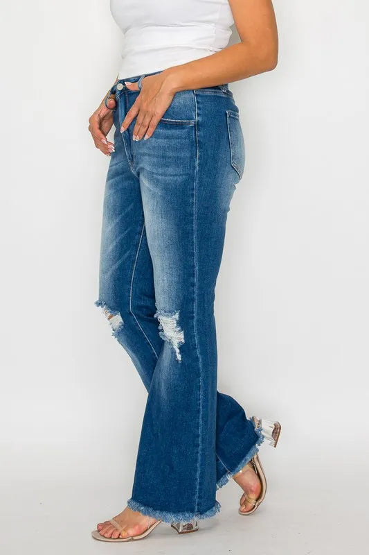 Person wearing blue jeans with a white background