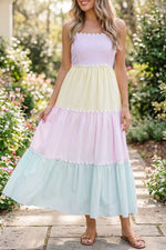 Woman wearing a pastel color-blocked dress in a garden setting