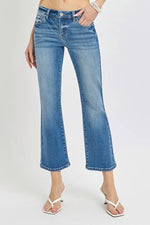 Blue jeans worn by a person on a white background