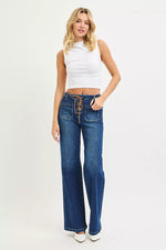 Woman wearing blue jeans and a white top on a white background