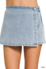 Light blue denim skirt worn by a person on a white background