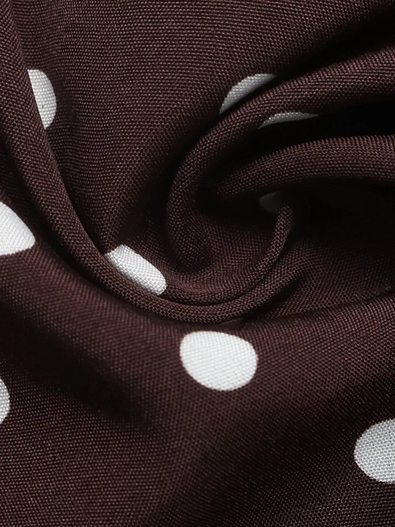 Brown fabric with white polka dots, close-up view