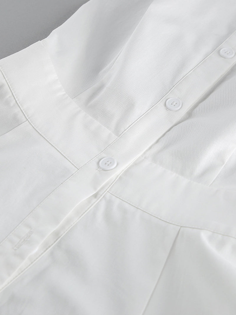 Close-up of a white shirt with buttons on a gray background