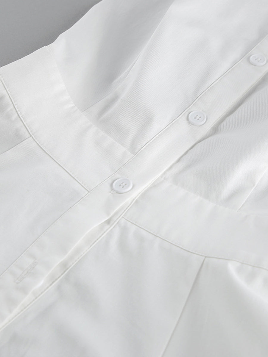 Close-up of a white shirt with buttons on a gray background