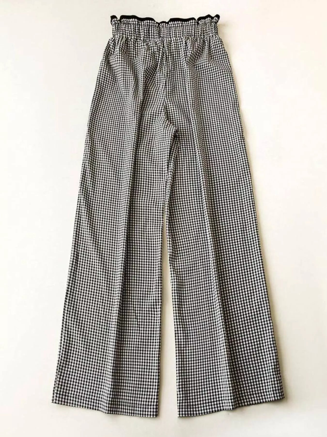 Black and white checkered pants on a white background