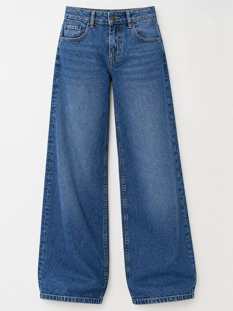 A pair of medium wash blue denim jeans with a wide-leg silhouette, laid flat against a light gray background.