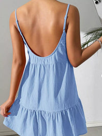 Light blue dress with thin straps on a neutral background