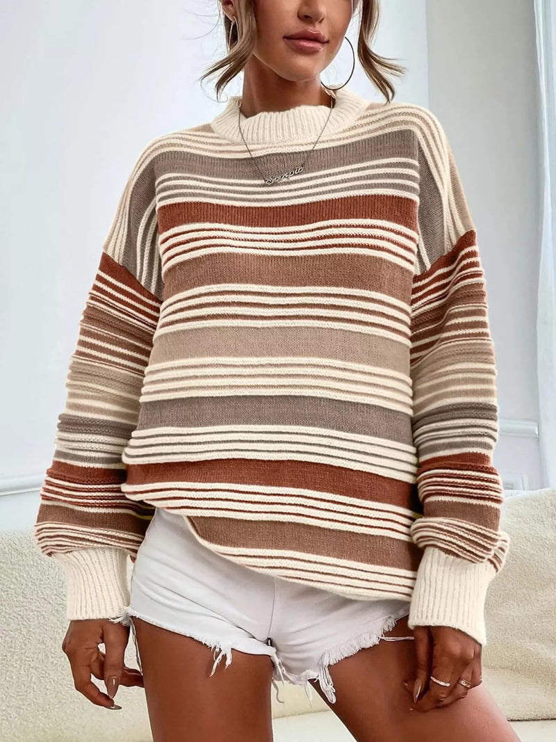 Person wearing a striped sweater and white shorts indoors