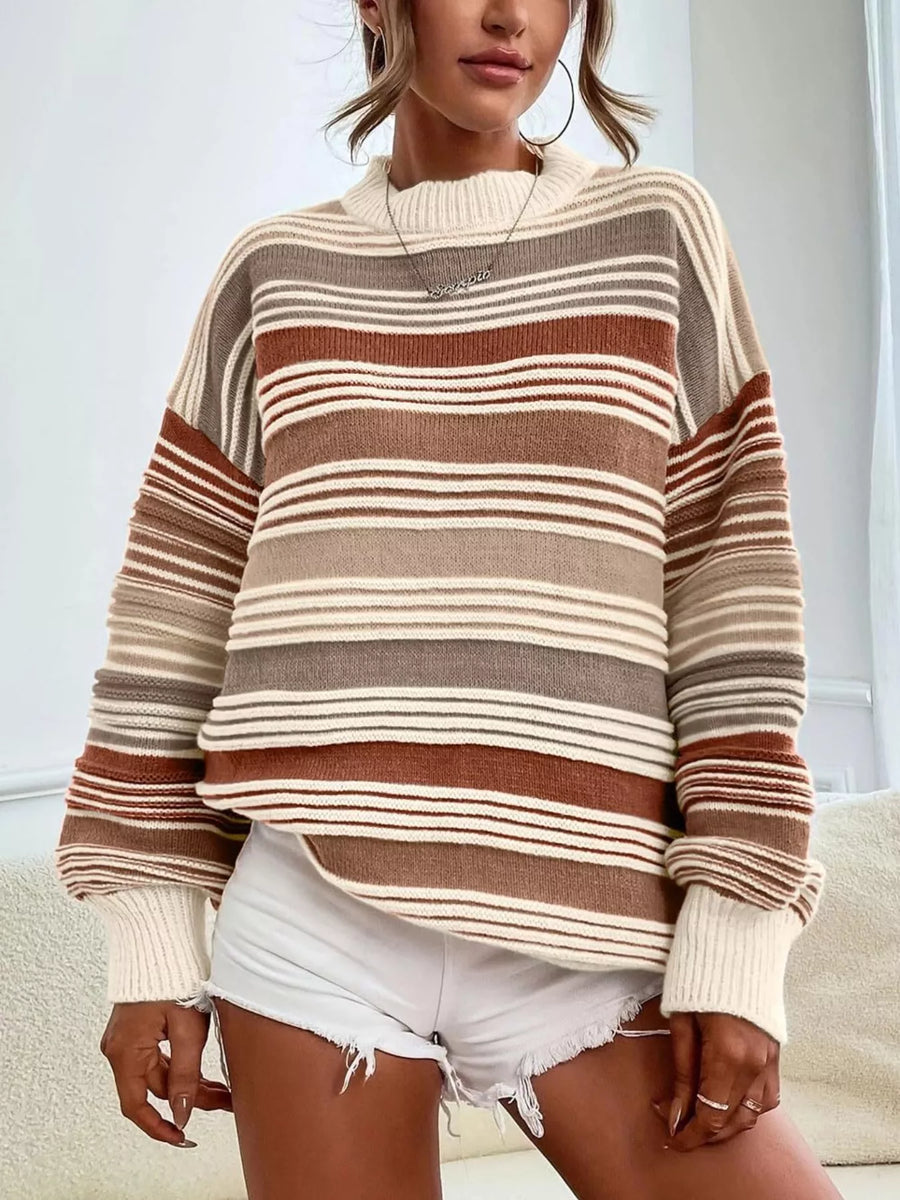 Person wearing a striped sweater and white shorts indoors