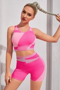 Woman wearing a pink athletic outfit against a white background